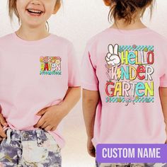 Back To School Kids Shirt, Hello Kindergarten Shirt, Personalized Girl Name Shirt, Custom Kids Name Toddler Girl Shirt, Kindergarten Outfits The Standard T-Shirt, personalized to suit your individual style, serves as the perfect medium for self-expression. Made from 100% preshrunk cotton, this timeless short-sleeve tee not only ensures comfort but also offers ample opportunities for print-on-demand customization. Whether you seek to showcase your creativity, promote your brand, or commemorate a Fun School Tops With Name Print, Pink T-shirt With Name Print For School, Cute School Tops With Name Print, Playful Pink Shirt With Letter Print, Pink Tops With Letter Print For School, Cute School Shirt With Name Print, Spring School Shirt With Text Print, Playful School Tops With Letter Print, Playful Letter Print Tops For School