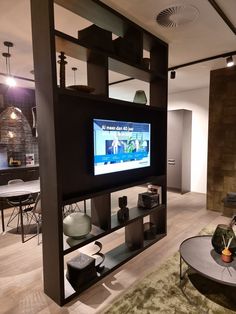 a living room with a large flat screen tv mounted to the side of a wall