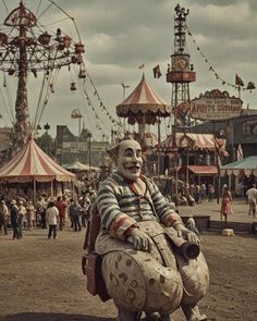 a creepy clown sitting in the middle of an amusement park