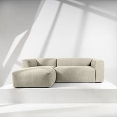 a couch sitting on top of a white floor