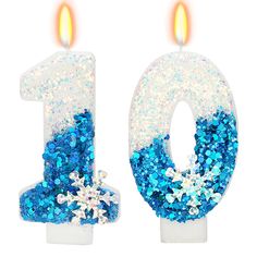 the number one candle is decorated with blue and white glitter