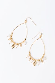 - Sip your mimosa with a sweet pop of pearls with these gorgeous earrings! - Gold colored metal material - A dangling teardrop shaped design with patterned beading featuring faux pearl accents - Hook backs - Size: 2.5 inches Teardrop Pearl Drop Chandelier Earrings For Party, Pearl Teardrop Hoop Earrings With Pearl Drop, Pearl Teardrop Dangle Earrings With Pearl Drop, Pearl Drop Teardrop Dangle Earrings, Pearl Teardrop Chandelier Earrings For Pierced Ears, Gold Teardrop Earrings With Pearl Charm, Gold Teardrop Pearl Earrings With Pearl Charm, Gold Teardrop Beaded Hoop Earrings, Gold Beaded Teardrop Earrings In Metal