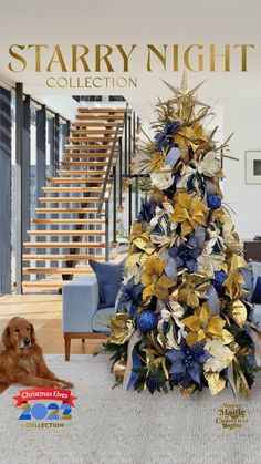 a blue and gold christmas tree in the middle of a living room next to stairs