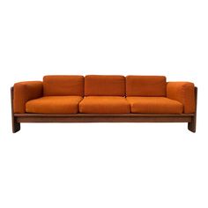 an orange couch sitting on top of a wooden frame