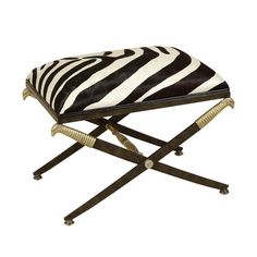 a zebra print stool with two legs and a cushion on the seat is shown in black and white