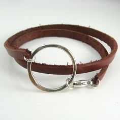 A chunky leather double wrap bracelet with a handcrafted circle centerpiece is ruggedly dainty. The leather is 5mm wide and 2mm thick and the sterling silver centerpiece measures about 1-1/4 inches (3 cm) wide. All held together with a sterling silver lobster clasp. Leather is available in Black, Brown, White and Dark Red-Brown.Please measure your wrist to find the best size for you. Add length based on whether you prefer a looser or tighter fit and select the size that best corresponds to your Leather Belt Crafts, Leather Bracelet Tutorial, Diy Leather Bracelet, Hardware Jewelry, Leather Jewellery, Brown Leather Bracelet, Double Wrap Bracelet, Cadeau Diy, Necklaces And Bracelets