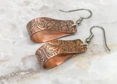 We are still taking Christmas orders until December 10th. Order early so your items arrive on time. 1.5 inch copper hoop earrings that dangle from surgical steel ear hooks. These earrings feature a tooled leather design that has been embossed on solid copper. Perfect for every day and those summer and fall nights out. These are light enough to wear all day but you will know they are there. The earrings are 8mm wide and dangle from the hooks at almost 2 inches long. Wear with jeans and a tshirt o Etched Copper Jewelry, Hammered Copper Earrings, Unique Hoop Earrings, Copper Jewellery, Crescent Earrings, Contemporary Earrings, Copper Bracelet, Large Hoop Earrings, Leather Texture