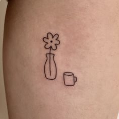 a woman's thigh with a flower and coffee cup tattoo on her left leg