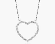 14K White Gold Lab-Created Diamond Open Heart Pendant Necklace. Slim and sparkling, make a simple statement of love with this classic lab-created diamond heart pendant. Crafted in 14K gold, this petite style features lab-created round brilliant-cut diamonds along the facing edge. This pendant is attached to a box chain and that secures with a spring-ring clasp. The necklace measures 18inches with an extra jump ring at 16 inches for versatility. Classic Heart Pendant Necklace In Cubic Zirconia, Classic Open Heart Diamond Necklace For Gift, Classic Open Heart Necklace With Brilliant Cut, Classic Open Heart Necklace With Diamond Accents, Classic Necklace With Brilliant Cut Open Heart, Classic Sterling Silver Diamond Necklace With Heart Charm, Classic Heart Necklace With Cubic Zirconia And Diamond Accents, Classic Heart Necklace With Diamond Accents In Cubic Zirconia, Classic Diamond White Heart Necklace In Cubic Zirconia