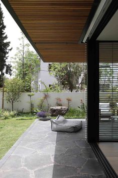 an outdoor patio area with concrete flooring and furniture