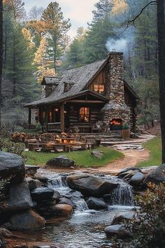 a log cabin in the woods with a stream running through it