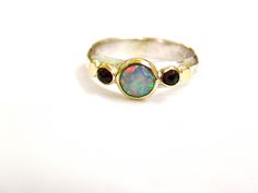 Recycled Silver and 14k Gold With White and Garnet stone (The listing is only for the ring with the stone) If you want it with the secend ring: https://www.etsy.com/listing/155717400/gold-ring-wedding-bands-stackable-rings?ref=shop_home_active_52 You are looking at a beautiful HAND MADE silver and 14k gold ring with lovely blue opal. The opal stone is setting in 14k gold bazel. It is impressive, powerful and very beautiful ring. Size White opal is 6mm Red garnet stone are 3 mm nickel free Multi Stone Rings, Stone Rings For Women, Ring Wedding Set, White Opal Ring, Garnet Stone, Recycled Silver, Opal Stone, 14k Gold Ring, Wedding Set