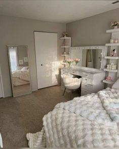 a bedroom with a bed, desk and mirror in it's centerpieces