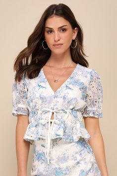 Get ready for the compliments, 'cause you'll be collecting them left and right in the Lulus Positively Beloved Ivory Floral Embroidered Tie-Front Top! Lightweight woven fabric boasts an abstract floral print and darling eyelet embroidery as it shapes short puff sleeves with ruffles and elastic at the cuffs. Bodice has a plunging V-neckline that finishes at twin functional drawstring ties, all atop a ruffled hem. Pair with the matching skirt for a complete look! Fit: This garment fits true to siz White Lace Blouse With Floral Print, Spring Wedding Floral Print Tops, True Summer Outfits, True Summer, Peach Love, Eyelet Embroidery, Cool Summer Outfits, Womens Fashion Casual Summer, Trendy Fashion Tops