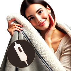 a woman is holding up a blanket with an electric toothbrush in the middle of it