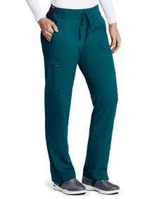 The Grey's Anatomy Spandex STRETCH GRSP500 Cargo Scrub Pant is a mid-rise, straight legged pant with a stretch knit waistband, a branded contrast knit back waistband, and a drawstring closure. This pant has ankle vents and 3 three pockets: two front slash pockets, with a D-ring below the left slash pocket, and one cargo pocket on the right with a zipper closure. Made of 74/23/3 poly/rayon/spandex twill. Grey's Anatomy © ABC Studios. All Rights Reserved. Approx. inseam for Medium is 31". Fun Scrubs, Cargo Scrub Pants, Dickies Scrubs, Greys Anatomy Scrubs, Uniform Advantage, Easy Stretches, Bahama Blue, Medical Uniforms, Scrub Pants