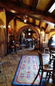 a dining room with an archway leading into the kitchen