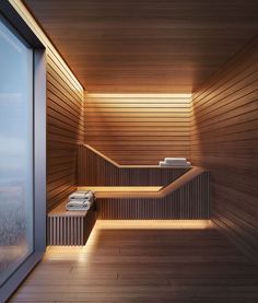 an indoor sauna with wooden walls and lighting on the floor, along with two benches