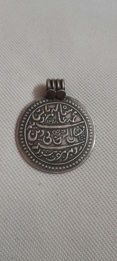 Handmade 92.5 Sterling Silver Hammer Stamped Islamic Religious Urdu Letter Aayet A Qaraan Prayer (dua)  Holy words Oxidized Pendant Made By my shop member Primary Color of Pendant is oxidized Silver Pendant Details : Weight of Pendant is 13.9 Gms. Length of Pendant is 4.6 cm.with Loop Width of Pendant is 3.7 cm Thickness of Pendant is 1 mm inner diameter of Pendant Loop is 7 mm It's a totally Handmade Islamic muslim Holy Pendant from Rajasthan state northern India Traditional Silver Necklace For Eid, Traditional Coin Necklace Gift, Letter Pendants, Oxidized Silver, Hammered Silver, Handmade Pendant, Handmade Pendants, Sterling Silver Pendant, Sterling Silver Pendants