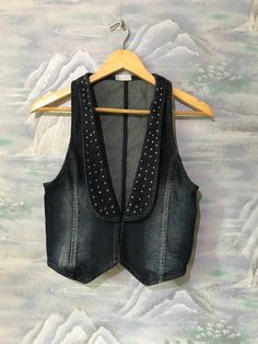 "Vintage Extra Small Size Vest Denim Vest Women Jeans Vest Blue Denim Vest Fitted Waistcoat Jeans Waistcoat Extra Small to Small Waistcoat Label size: 34 Estimated size: XS/S Measurements (lying flat): Length: 19,2\" - 49 cm Pit to pit: 14,5\" - 37 cm Waist: 13,7\" - 35 cm Please check measurements to insure a proper fit. Remember to allow yourself some extra room for movement. You can compare these with something from your closet that fits you well. This vest will come to you freshly laundered Trendy Fitted Denim Top For Winter, Fitted Denim Vest With Pockets For Winter, Fitted Winter Denim Vest With Pockets, Winter Fitted Denim Vest With Pockets, Trendy Fitted Denim Vest For Winter, Fitted Denim Vest For Winter, Fitted Denim Top For Winter, Trendy Denim Blue Winter Vest, Trendy Dark Wash Denim Vest For Winter