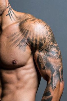 a man with tattoos on his arm and chest