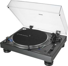 a turntable that is sitting on top of a white surface with the lid open