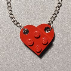 The necklace is handmade by AFOL (An Adult Fan of LEGO) using LEGO plates with a 20inch stainless steel linked chain. May have imperfections. Adjustable Red Personalized Necklace, Red Pendant Chain Jewelry, Red Pendant Necklace With Chain, Adjustable Red Chain Jewelry, Red Pendant Necklace With Lobster Clasp, Red Round Chain Jewelry, Red Chain Necklace With Lobster Clasp As Gift, Red Nickel-free Pendant Necklace, Red Sterling Silver Necklace With Adjustable Chain