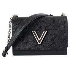 100% authentic Louis Vuitton Twist MM in black Epi leather with silver-tone hardware. The design features the iconic LV turn-lock on the front. The sliding chain strap can be doubled for shoulder carry or lengthened for cross-body wear. Lined in black microfiber with an open pocket against the front and back. Has been carried and is in excellent condition. Comes with dust bag. Measurements Height 17cm (6.6in) Width 23cm (9in) Depth 9cm (3.5in) Drop of the Handle 30cm (11.7in) Shoulder Strap Leng Louis Vuitton Black, Bag Measurements, Louis Vuitton Twist, Authentic Louis Vuitton, Fashion Handbags, Chain Strap, Cross Body, Bags Handbags, Dust Bag