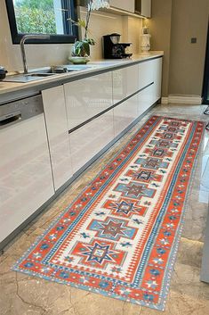 an orange and blue runner rug in a kitchen