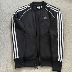 Never Used In Excellent Condition. Size: 2xs. Smoke- Free Home. Adidas Fitted Casual Track Jacket, Adidas Fitted Track Jacket For Streetwear, Fitted Casual Adidas Track Jacket, Adidas Spring Outerwear With Three Stripes Branding, Casual Adidas Outerwear With Three Stripes, Fitted Three Stripes Track Jacket For Streetwear, Long Sleeve Outerwear With Three Stripes For Spring, Adidas Black Outerwear With Three Stripes Branding, Adidas Three Stripes Spring Outerwear