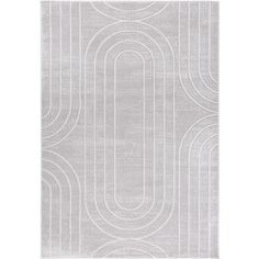 a white rug with circles and lines on the floor in front of a white background