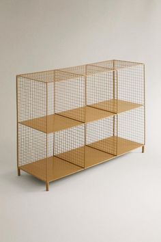 an animal cage with four shelves on each side