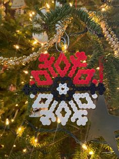 a christmas ornament hanging from a tree with lights on it and the word sale spelled out