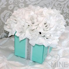 a blue box with white flowers in it