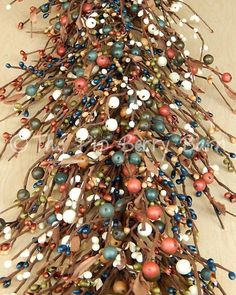 an arrangement of beads and branches on a table