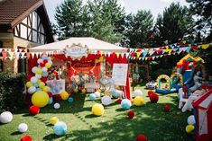 an outdoor birthday party with balloons and decorations