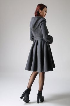 "Crafted in soft winter wool, this beautiful belted swing coat is an elegant cover-up this season. Cinched at the waist, it will give any lady a stunning silhouette that is bound to turn heads! Cozy has never been so chic. You hurry up the path to your best friend's house with freshly baked treats. You're wrapped in this hooded winter wool gray coat and you're toasty warm and ready for a giggle-filled girls' night in. Your friend greets you at the door and raves to all your pals about your delec Solid Knee-length Winter Outerwear, Elegant Hooded Wool Coat For Winter, Black Wool Coat Women, Hooded Wool Coat, Gray Coat, Modern Womens Fashion, Wool Winter Coat, Office Chic, Black Wool Coat