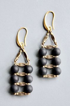 18k gold plated brass hooks with matte jet glass and oxidized brass. Each half pair weighs .25 oz and measures 2.5 inches. Elegant Black Jewelry With Antique Finish, Elegant Brass Jewelry With Brass Hardware, Elegant Jewelry With Brass Hardware, Elegant Adjustable Matte Black Jewelry, Elegant Matte Black Adjustable Jewelry, Matte Black Elegant Jewelry For Formal Occasions, Elegant Matte Black Jewelry For Formal Occasions, Black Metal Jewelry With Antique Finish, Black Oxidized Brass Jewelry