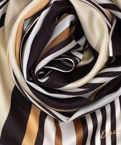 This versatile 100% silk scarf adds an accent in bold colors or striking neutrals. Tie it around the neck, wear it as a flowing head wrap, or even transform it into an eye-catching summer top. Dimensions: 13 in. x 72 in. Materials: 100% Silk Chic Brown Silk Scarf, Chic Brown Scarf For Summer, Chic Brown Summer Scarf, Chic Brown Scarves For Summer, Chic Multicolor Silk Scarves, Green Eggplant, Purse Scarf, Wide Stripes, Stripe Silk