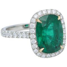 an oval emerald and diamond ring