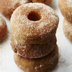 several sugared donuts stacked on top of each other