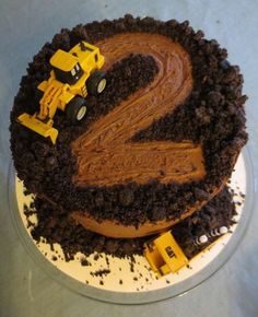 a cake with chocolate frosting and construction vehicles on it