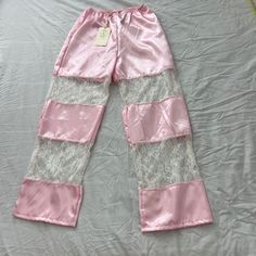 Urban Outfitters Lace Insert Silky Pull-On Pant Size S/M Condition: Nwt Color: Pink / White Details : - Silky Pants From Urban Renewal With Lace Paneling And An Elastic Waistband Approx. Measurements: - Length: 39 Inches - Rise: 12 Inches - Inseam: 30 Inches - Waist: 28 Inches - Leg Opening: 9 Inches Extra: - I Ship Between 1-2 Days Urban Outfitters High-waisted Pink Bottoms, Urban Outfitters High Waist Pink Bottoms, Urban Outfitters Wide Leg Pants For Spring, Urban Outfitters Wide Leg Spring Pants, Urban Outfitters Wide-leg Pants For Spring, Chic Pink Bottoms For Pajama Party, Pink Wide Leg Sleepwear For Spring, Urban Outfitters White Summer Pants, White Wide Leg Bottoms From Urban Outfitters