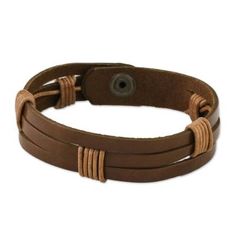 Chaloemphon of Thailand presents this men's leather wristband bracelet. The light brown leather has three horizontal slits. The artisan has wrapped two sections in black leather cord in artful intervals adding to the bracelet's texture and visual impact. The bracelet closes with a brass snap. Brown Leather Strap Wristband, Adjustable Vintage Brown Bracelet For Gift, Adjustable Vintage Brown Bracelet As Gift, Adjustable Brown Leather Bracelet With Wrist Strap, Adjustable Vintage Brown Bracelets As Gift, Brown Leather Bracelet With Adjustable Band, Adjustable Brown Wristband With Bracelet Strap, Adjustable Brown Bracelet With Wrist Strap, Adjustable Brown Band Bracelet