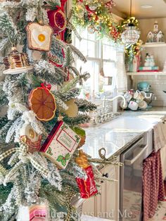 a decorated christmas tree in a kitchen