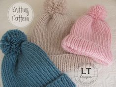 three knitted hats with pom - poms are shown on a white surface