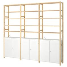 a wooden shelving unit with two white cupboards and three doors on each side