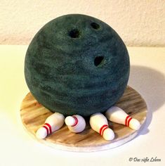 a bowling ball and pins on a wooden board