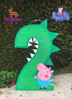 peppa the pig is standing in front of a green number two with his mouth open