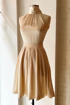 Stunning champagne silk mini dress by Blumarine with backless scarf-like halter design. Era: Y2K Fits size XS-S Excellent condition Cream A-line Evening Dress For Party, Cream Satin Party Dress, Fitted Silk Backless Dress For Party, Cream Satin Mini Dress For Night Out, Cream Fitted Satin Evening Dress, Party A-line Midi Dress With Tie Back, Chic Halter Dress With Keyhole Back For Party, Cream Satin Dress For Summer Party, Gold Sleeveless Satin Mini Dress